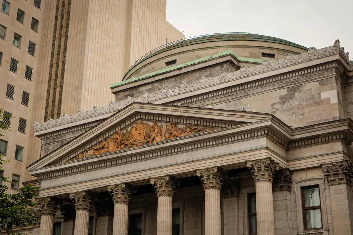 A detailed view of a historic Neo-Classical building facade in downtown Montreal.